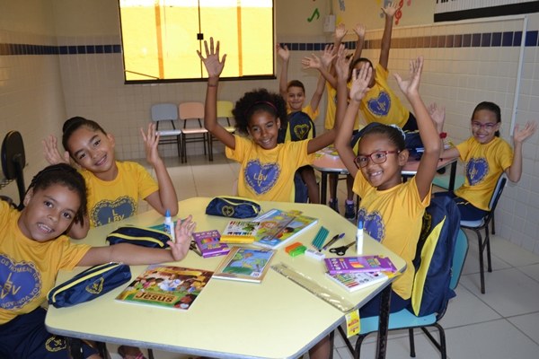 Criancas felizes com os kits para o incentivo ao estudo.JPG